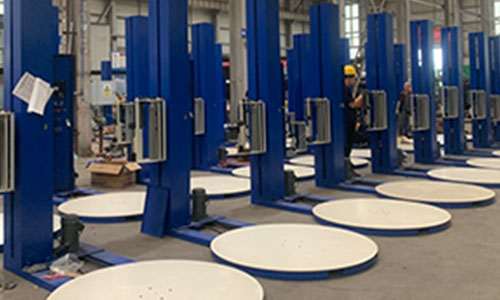 How does the automatic stretch wrapping machine help companies save 30% on packaging costs?